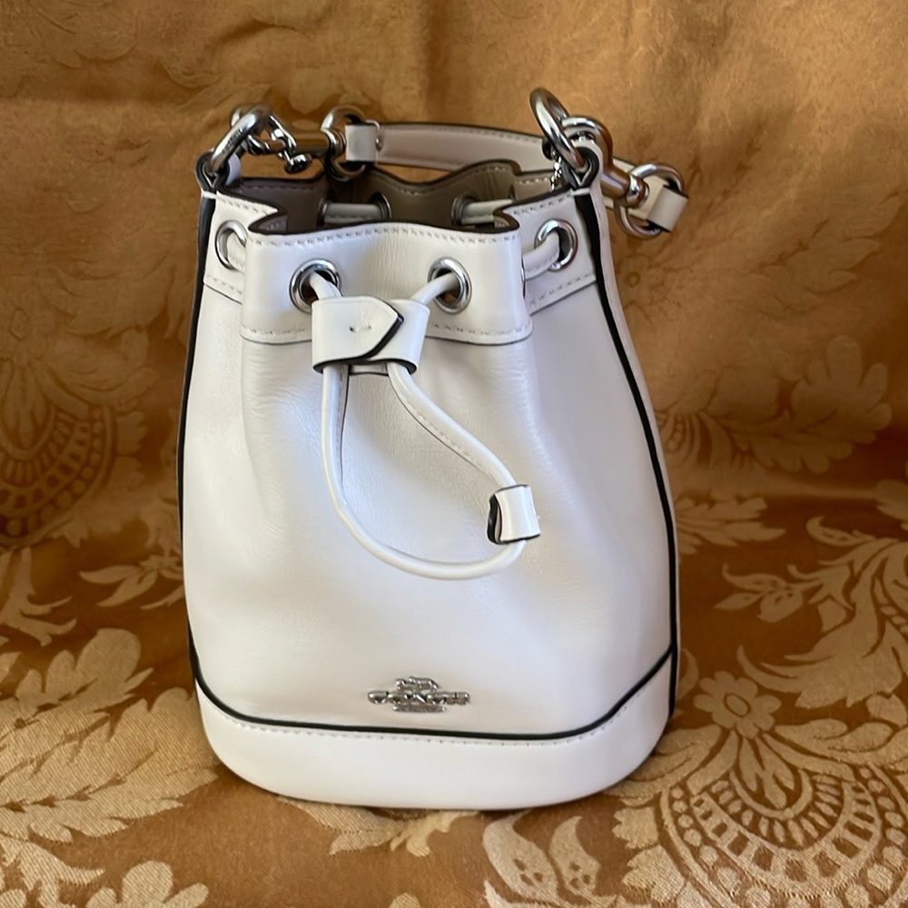 Coach mini bucket bag in chalk with silver accents. NWT.